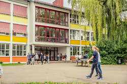 Auf dem Bild ist der Schulhof sowie die Außenansicht eines Gebäudes der Realschule auf dem Galgenberg zu sehen.